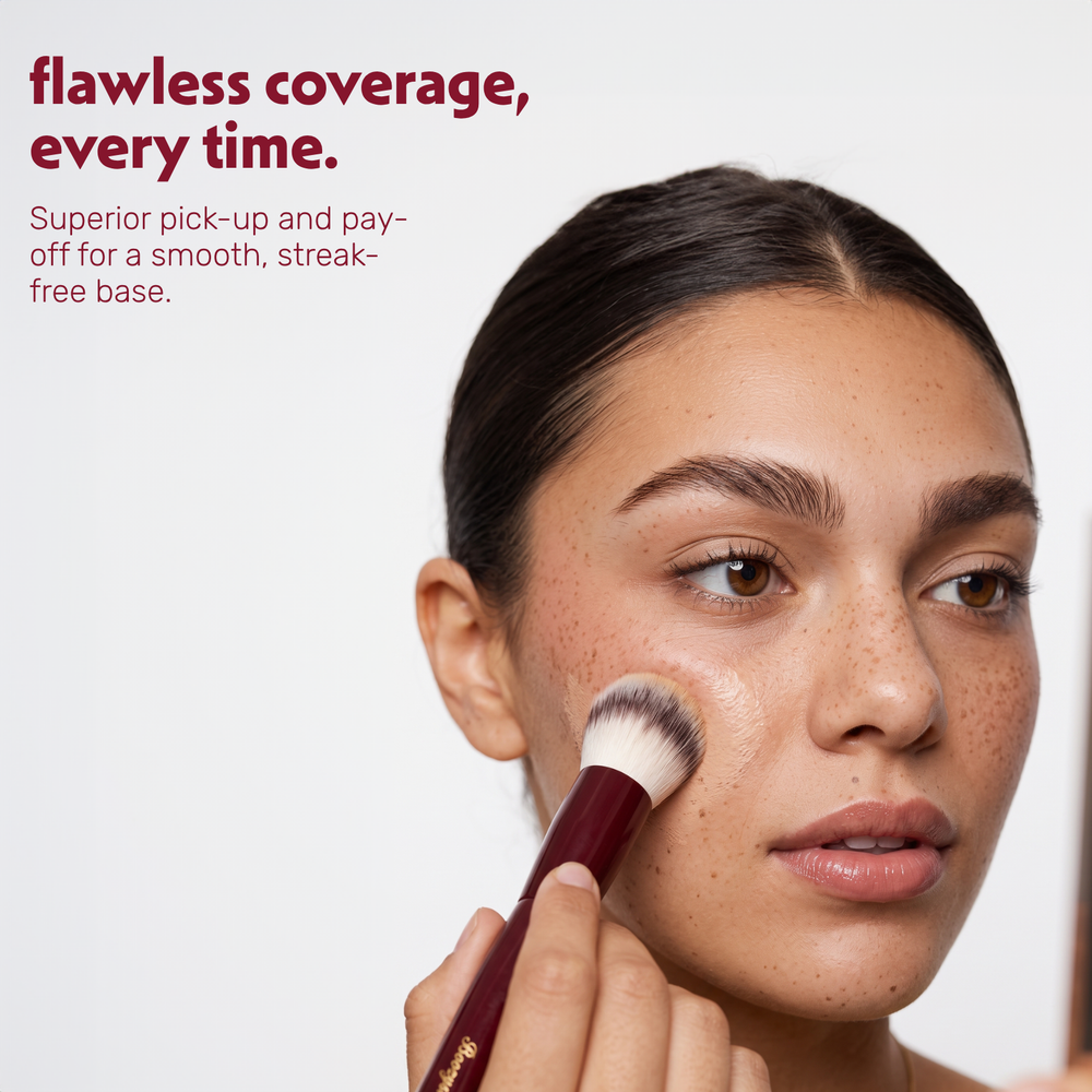 Model applies foundation to the face with the Boozyshop Flawless Round Foundation Brush